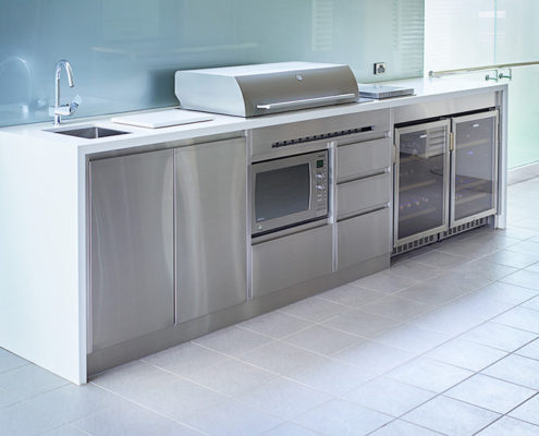 A bespoke barbecue area in Perth complete with sink, microwave, hotplate, wine fridges and storage