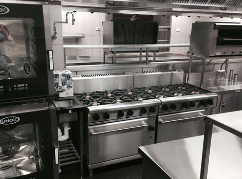 Stainless steel cook tops manufactured by Metro Steel Services & installed in a commercial kitchen