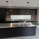 Beautiful modern kitchen with custom stainless steel bench tops
